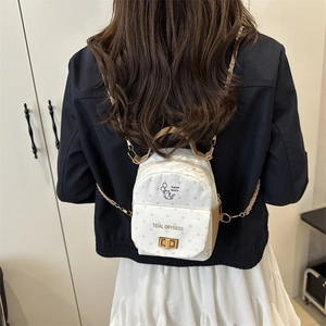 Chic white polka dot mini backpack for women with gold chain strap and metal lock closure