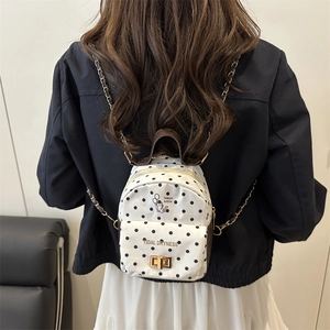 Polka dot canvas mini backpack for women featuring leather handle and chain straps