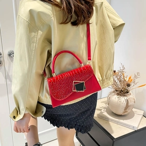 Red crossbody bag for women with crocodile pattern flap and elegant gold-trimmed buckle