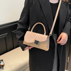 Elegant beige leather crossbody bag with crocodile pattern flap and gold square clasp