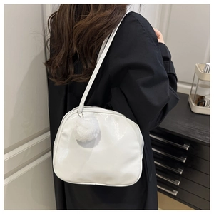 Glossy white faux leather shoulder bag with a soft plush ball charm decoration