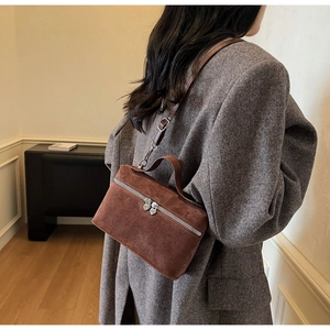 Brown suede crossbody box bag shown on model with silver double zippers and slim strap