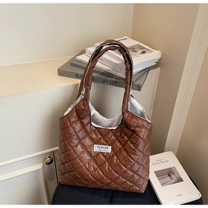 Close-up of brown quilted nylon tote bag featuring Fashion Instinct logo on fabric