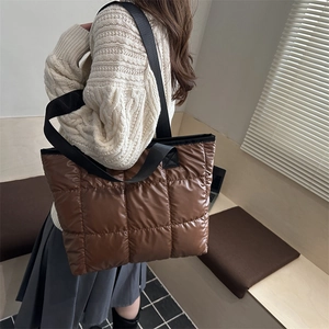 Brown quilted puffer tote bag for women showing a stylish large capacity shoulder carry