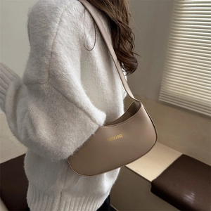 Chic apricot half-moon shoulder bag in premium PU leather worn by a model