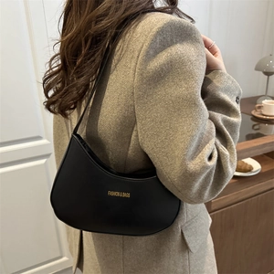 Black leather hobo bag for women featuring gold logo and minimalist moon shape design