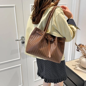 Brown woven tote bag with shoulder strap and vintage metal buckle for daily commute