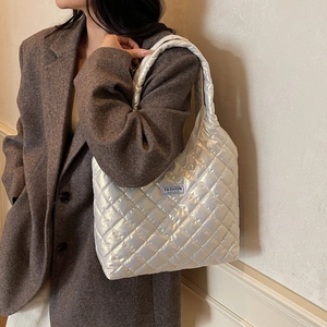 Silver quilted down tote bag with a metallic finish and fashion label for women