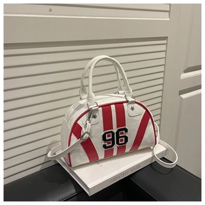 Detail view of white Boston bag with red stripes and number 96 patch on a book