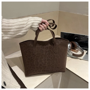 Detail of dark brown leopard print tote bag with suede texture and adjustable strap