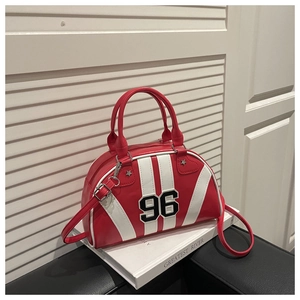 Detail of red and white bowling bag with number 96 patch and star rivets on a book