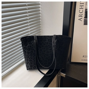 Detail of black leopard print velvet tote bag with slim leather shoulder straps