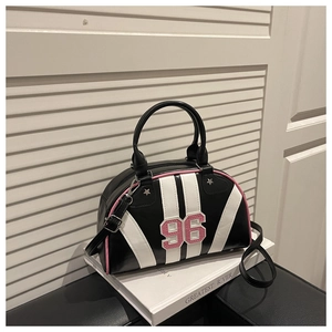 Detail of retro bowling bag featuring number 96 patch and pink trim on a white book