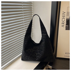 Detail of hobo shoulder bag with black leopard print texture on soft fabric material
