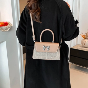 Minimalist crossbody square bag with pink flap and silver sequins for women in lifestyle setting