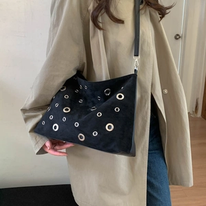 Women's black suede tote bag with silver eyelets and punk style shoulder strap