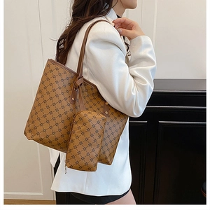 Detail of vintage tote bag with geometric pattern and matching small pouch on a model