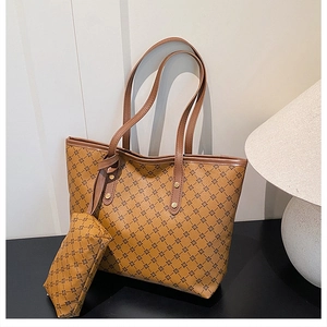 Detail view of brown tote bag with geometric floral pattern and golden metal rivets