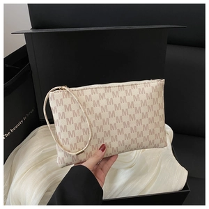 Close-up of stylish cream clutch bag with purple letter print and matching wrist strap
