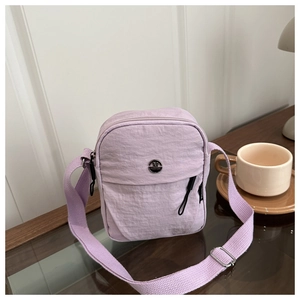 Detail of lavender nylon mini crossbody bag with metal logo and thick adjustable strap