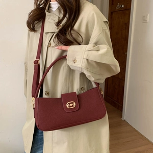 Chic burgundy rectangular crossbody bag with golden horsebit buckle and slim shoulder strap