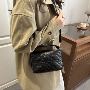 Fashionable black crossbody bag with heart-quilted pattern and metallic zipper detail
