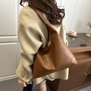 Large brown leather tote bag for women with minimalist slouchy design and retro texture