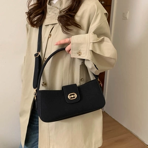 Classic black canvas baguette bag with golden metal ring and adjustable strap for women
