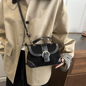 Minimalist black suede crossbody bag with contrast stitching and gold hardware detail