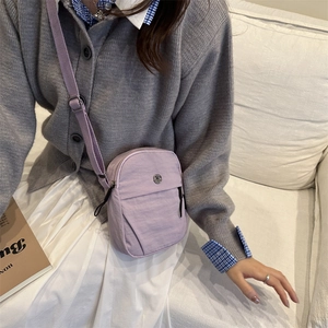 Minimalist lilac nylon crossbody bag for women with silver metal logo and zip pockets