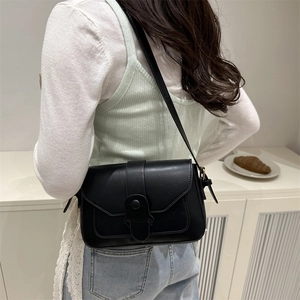 Minimalist black square crossbody bag for women with envelope flap and sleek shoulder strap