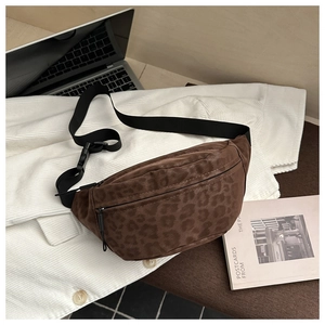 Detail of leopard print crossbody bag with adjustable strap and textured fabric finish