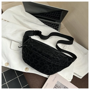 Close-up of black leopard print chest bag on a white jacket with a magazine backdrop