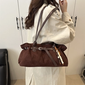 Retro dark brown suede tote bag with decorative buckle and wooden bead charm on shoulder