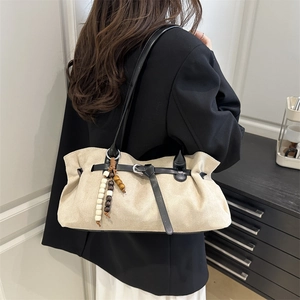 Minimalist beige suede tote bag with black leather straps and wooden bead charm for women