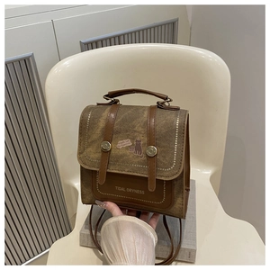 Detail of vintage patchwork mini backpack featuring cat illustration and metal buckle