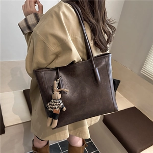 Large dark brown leather tote bag with vintage texture and cute bunny charm for daily use