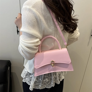 Pink minimalist PU leather crossbody bag with golden oval buckle and top handle for women