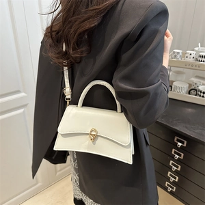 Minimalist white leather crossbody bag with gold buckle and adjustable strap for women
