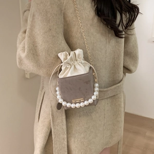 Chic box bag with pearl handle and gold chain strap in light brown and cream