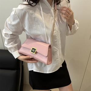 Pink crossbody bag with gold chain strap and square M letter buckle for elegant women