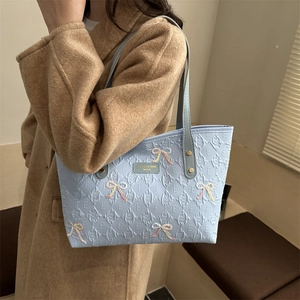 Light blue faux leather tote bag with geometric texture and sequin bow embroidery