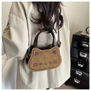 Detail of khaki cat-shaped shoulder bag with face embroidery and adjustable strap
