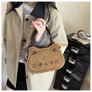 Detail of creative cat-shaped suede handbag with embroidery and top handle design