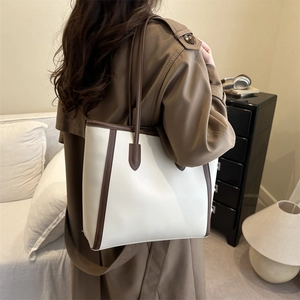 Retro cream and brown contrast leather tote bag styled on a trench coat model
