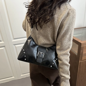 Sac à bandoulière chic en cuir noir avec rivets argentés et boucle élégante