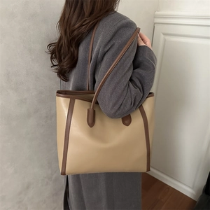 Minimalist bicolor leather tote bag for women with spacious design and slim shoulder straps