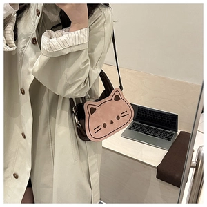 Pink cartoon cat-shaped shoulder bag shown from a mirror-selfie perspective