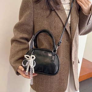 Elegant black mini square bag with pearl bow pendant and crossbody strap for women