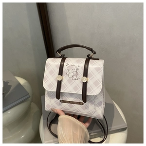 Detail of checkered PU leather backpack with cute bear print and metal brand tag